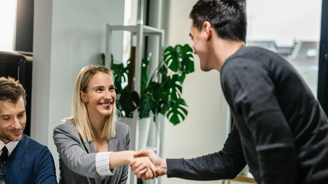decorative image of a couple shaking hands with someone