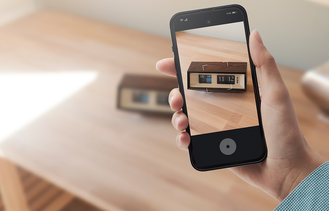 decorative image: person taking a picture on their phone of an old alarm clock